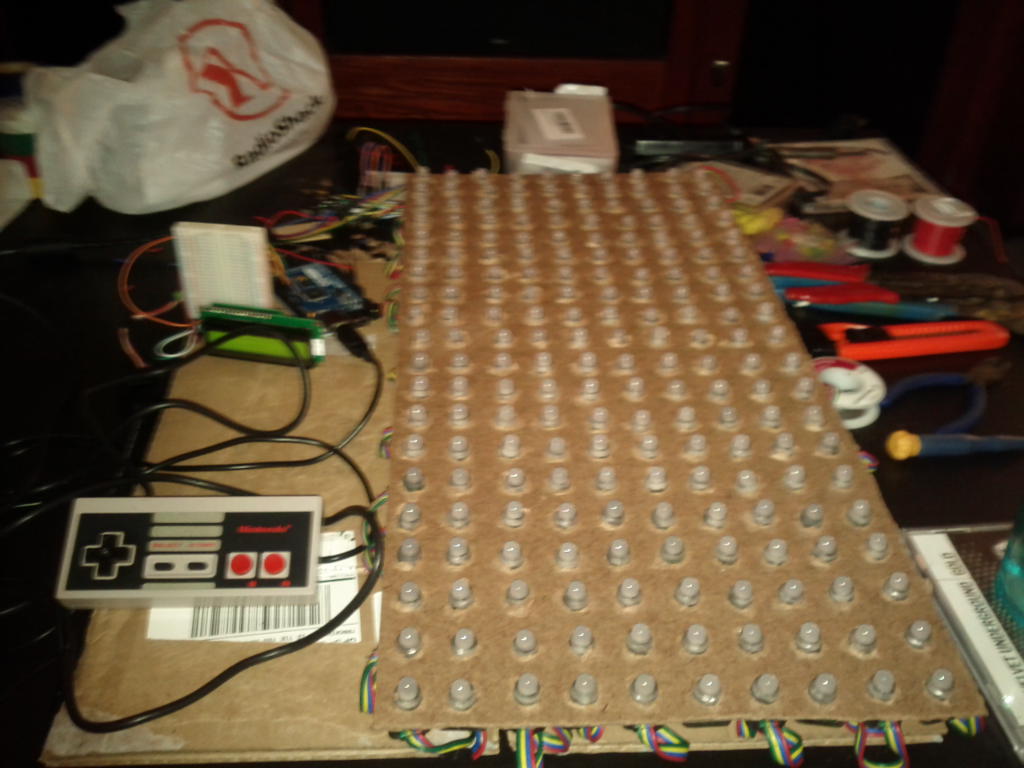 An early LED panel prototype beside a game controller