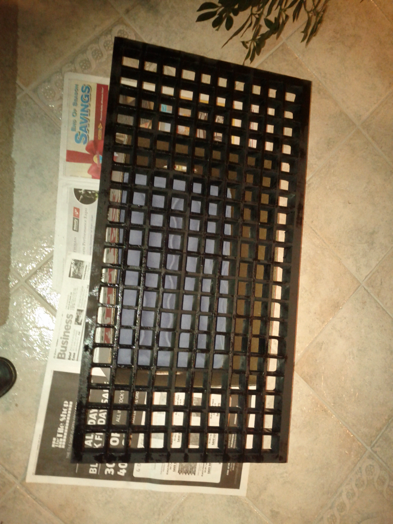 The dark grid panel laid out on the floor